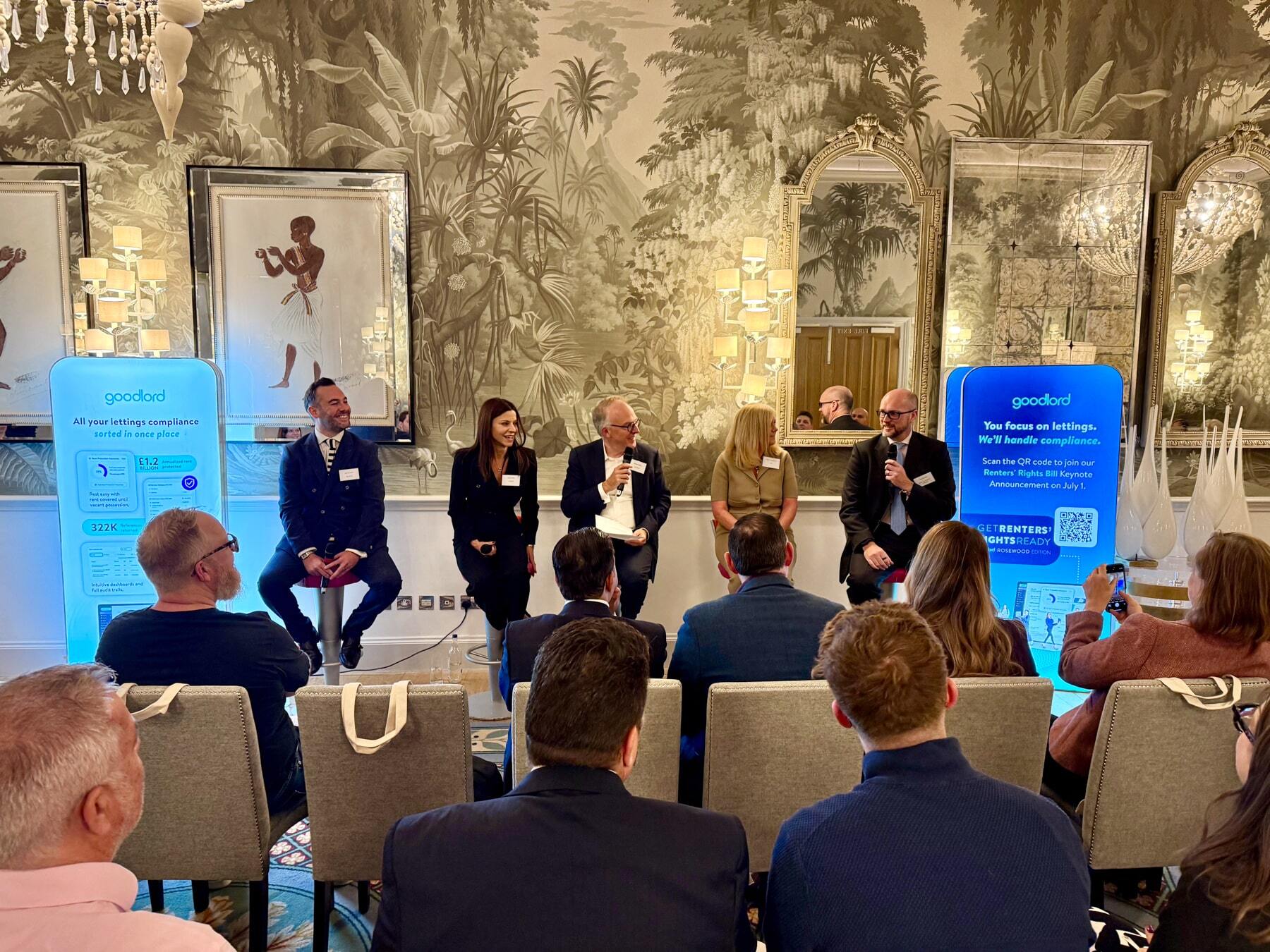 Four panellists, Oli Sherlock, Lucy Jones, William Reeve,  Allison Thompson, and David Smith, sit in a line in front of a crowd. 
