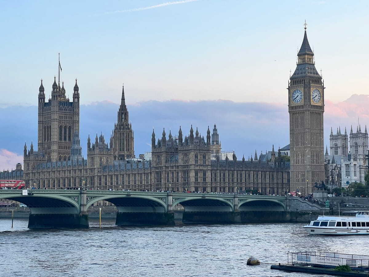 The UK Houses of Parliament, framed against an evening sky. 
