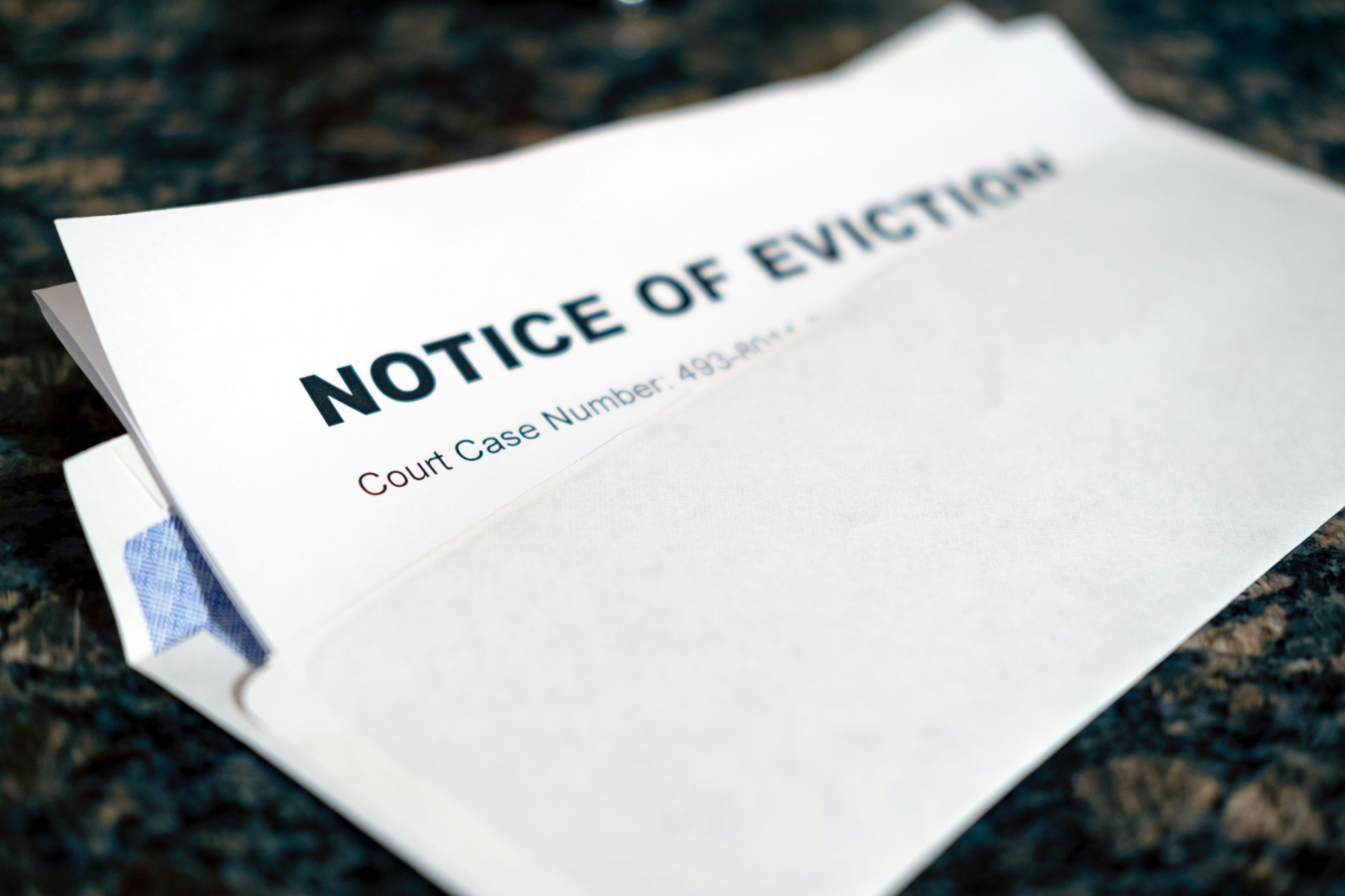 Partially opened envelope showing an eviction notice. 